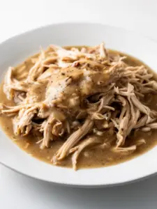 Slow Cooker Chicken and Gravy dish with tender chicken and rich gravy served in a bowl.