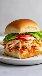 Delicious Bang Bang Chicken Sliders served with fresh toppings