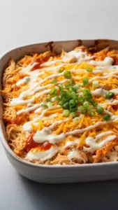 Delicious Buffalo Chicken Cheese Bake topped with melted cheese and spicy buffalo sauce.