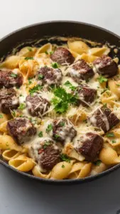 Cajun steak bites served with cheesy garlic pasta in a delicious dish.