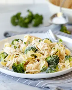 Creamy rotisserie chicken broccoli pasta dish served in a white bowl