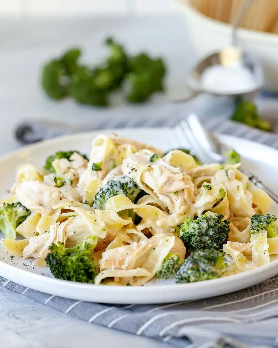 Creamy rotisserie chicken broccoli pasta dish served in a white bowl