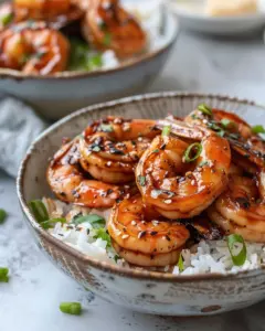 Delicious honey garlic shrimp bowl garnished with green onions and sesame seeds
